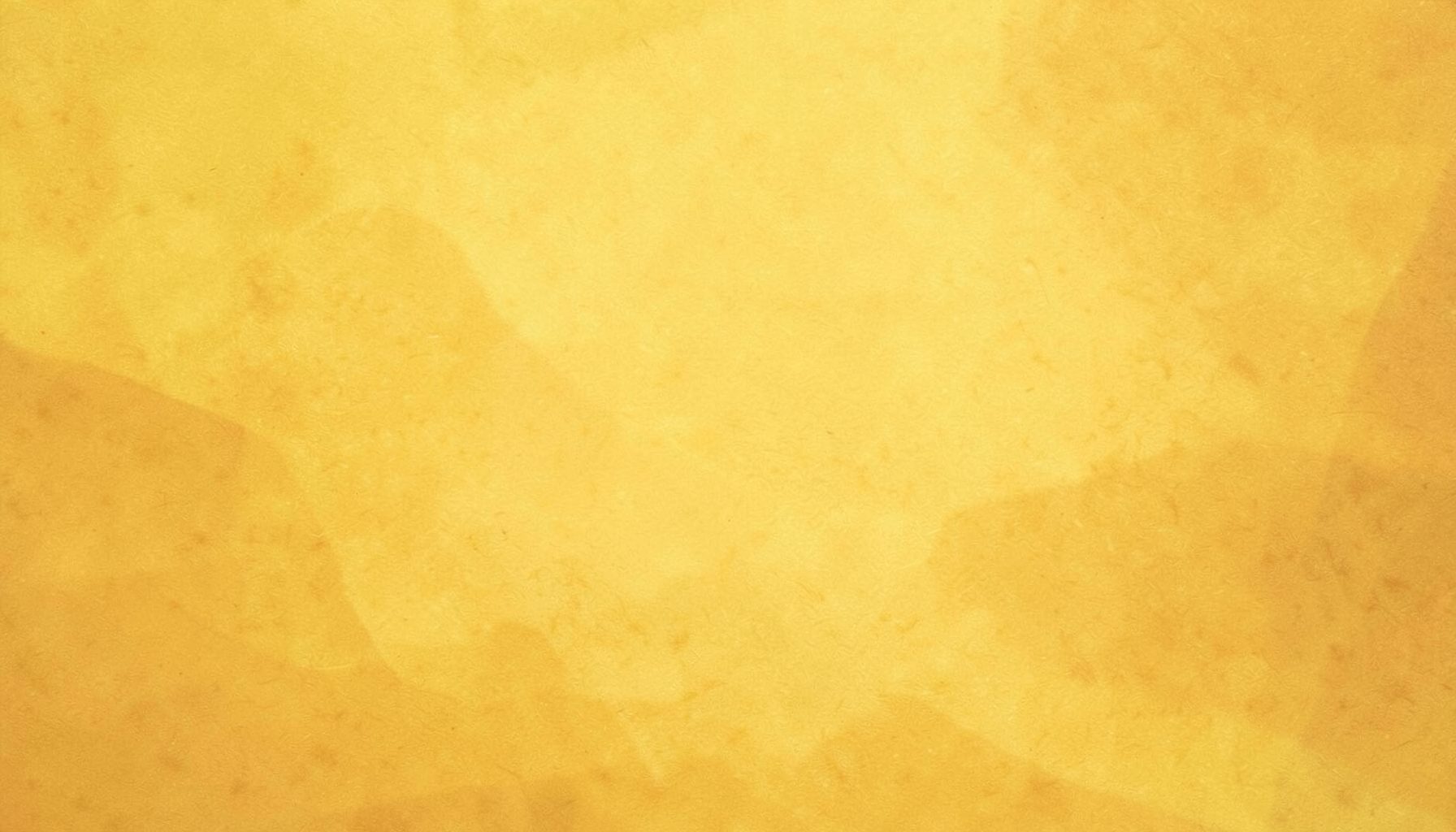 A warm golden-yellow abstract background with subtle paper-like texture, evoking a desk workspace feel