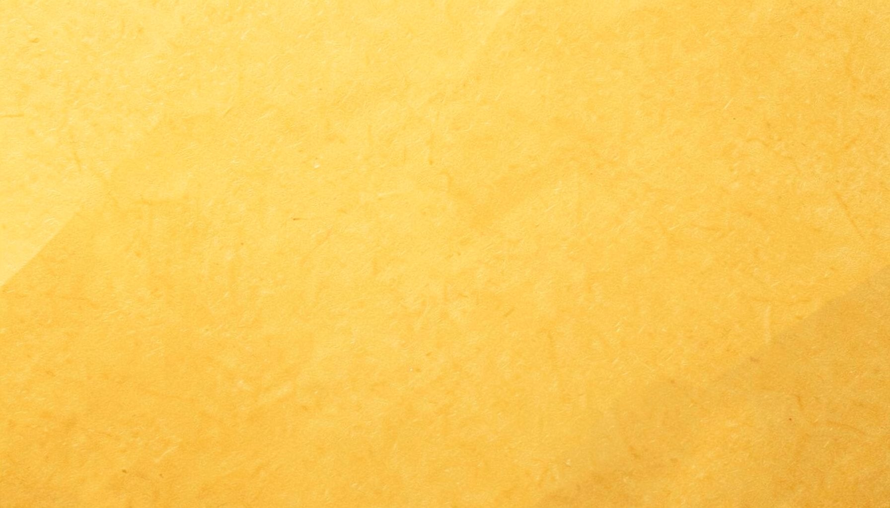 A warm golden-yellow abstract background with subtle paper-like texture, evoking stationery and formal correspondence